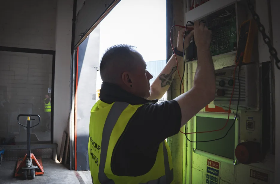 ADS Group engineer completing a fire system service record on site